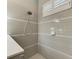 Modern shower with neutral tile and a rainfall shower head at 12715 Lake Silver Ave, Bradenton, FL 34211