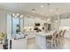Bright kitchen boasts white cabinets, quartz countertops, and an island with seating at 12715 Lake Silver Ave, Bradenton, FL 34211