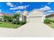 Lovely home showcases a well-maintained exterior with an attached two-car garage and beautiful landscaping at 12715 Lake Silver Ave, Bradenton, FL 34211