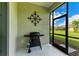 Screened porch with grill and outdoor furniture at 12715 Lake Silver Ave, Bradenton, FL 34211
