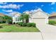 Single-story home with two-car garage and landscaped front yard at 12715 Lake Silver Ave, Bradenton, FL 34211