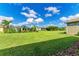 Spacious backyard with grassy area and view of homes at 12715 Lake Silver Ave, Bradenton, FL 34211
