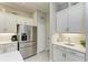 Modern kitchen features stainless steel appliances and ample white cabinetry at 12715 Lake Silver Ave, Bradenton, FL 34211