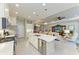 Open kitchen features a large island with seating overlooking the living room at 12715 Lake Silver Ave, Bradenton, FL 34211