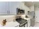 Modern kitchen with stainless steel appliances and white quartz countertops at 12715 Lake Silver Ave, Bradenton, FL 34211