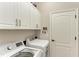 Laundry room with washer, dryer, and cabinets at 12715 Lake Silver Ave, Bradenton, FL 34211