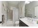 Clean bathroom with tub and shower, dark vanity at 12715 Lake Silver Ave, Bradenton, FL 34211