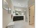 Elegant bathroom with double vanity, walk-in shower, and tile floors at 12715 Lake Silver Ave, Bradenton, FL 34211