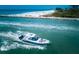 Aerial view of a boat cruising near the shoreline at 550 Flamingo Dr # 202, Venice, FL 34285