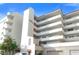 Modern building exterior with balconies and garage at 550 Flamingo Dr # 202, Venice, FL 34285