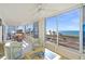 Sunroom with ocean views and comfortable seating at 550 Flamingo Dr # 202, Venice, FL 34285