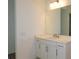 Bright bathroom featuring a modern vanity, white cabinets, and a large mirror at 705 Anegada Ln, Sarasota, FL 34234