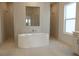 Modern bathroom featuring a free standing tub and glass shower at 705 Anegada Ln, Sarasota, FL 34234