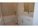 Bathroom featuring a bathtub with shower and a vanity with white cabinets at 705 Anegada Ln, Sarasota, FL 34234