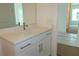 Bathroom vanity with white cabinets, stone countertop and chrome faucet and hardware at 705 Anegada Ln, Sarasota, FL 34234