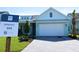 Charming, light blue single Gathering home with a pristine white garage door and paver driveway at 705 Anegada Ln, Sarasota, FL 34234
