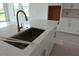 Stainless steel faucet and sink featured on a large quartz countertop kitchen island at 705 Anegada Ln, Sarasota, FL 34234