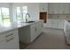 Bright kitchen features a large center island, stainless steel sink and plenty of cabinet space at 705 Anegada Ln, Sarasota, FL 34234