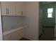 Functional laundry room with built-in cabinets and a countertop at 705 Anegada Ln, Sarasota, FL 34234