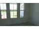 Bright living room featuring three large windows offering plenty of natural light at 705 Anegada Ln, Sarasota, FL 34234