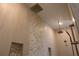 The shower features double fixtures, stylish tile work and built-in shelves for optimal organization at 705 Anegada Ln, Sarasota, FL 34234