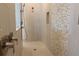 Modern shower features a mosaic tile accent wall, bronze fixtures, and a shower head at 705 Anegada Ln, Sarasota, FL 34234
