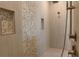 Modern shower features large-format tiles, accent wall with penny tiles and sleek bronze fixtures at 705 Anegada Ln, Sarasota, FL 34234