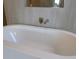 Close-up of a sleek soaking tub with stylish brushed-metal fixtures at 705 Anegada Ln, Sarasota, FL 34234