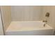 Close-up of a soaking tub featuring sleek, neutral tile at 705 Anegada Ln, Sarasota, FL 34234