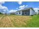Spacious backyard features green grass and a screened-in porch at 8175 Redonda Loop, Lakewood Ranch, FL 34202