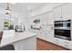 Modern kitchen with white cabinets, stainless steel appliances, and a quartz countertop island at 8175 Redonda Loop, Lakewood Ranch, FL 34202