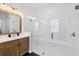Modern bathroom with glass-enclosed shower, vanity, and black tiled floor at 8175 Redonda Loop, Lakewood Ranch, FL 34202