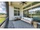 Screened patio boasts comfortable seating, ceiling fan, and serene outdoor views at 8175 Redonda Loop, Lakewood Ranch, FL 34202