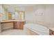 Spa-like bathroom featuring a large soaking tub and dual vanities at 130 Riviera Dunes Way # 306, Palmetto, FL 34221