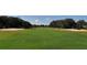 Scenic view of a lush green golf course with sand traps at 5822 Fairwoods Cir, Sarasota, FL 34243