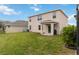 Spacious backyard with covered patio and grassy area at 17124 Harvest Moon Way, Lakewood Ranch, FL 34211