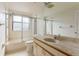 Clean bathroom with shower/tub combo, updated vanity, and large mirror at 5400 Eagles Point Cir # 104, Sarasota, FL 34231