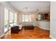 Living room with hardwood floors, large windows, and a beige sectional sofa at 235 Cocoanut Ave # 113C, Sarasota, FL 34236