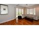 Living room with hardwood floors, large windows, and a beige sectional sofa at 235 Cocoanut Ave # 113C, Sarasota, FL 34236