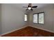 Well-lit bedroom with hardwood floors and ceiling fan at 235 Cocoanut Ave # 113C, Sarasota, FL 34236