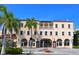 Exterior of a beautiful opera house with palm trees and a bright facade at 235 Cocoanut Ave # 113C, Sarasota, FL 34236