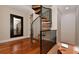 Elegant spiral staircase with metal railing and wood steps at 235 Cocoanut Ave # 113C, Sarasota, FL 34236