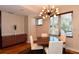 Dining room with hardwood floors, modern chandelier, and built-in cabinet at 235 Cocoanut Ave # 113C, Sarasota, FL 34236