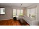 Spacious living room with hardwood floors, large windows, and a beige sectional sofa at 235 Cocoanut Ave # 113C, Sarasota, FL 34236