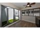 Private indoor patio with artificial turf and folding glass doors at 235 Cocoanut Ave # 113C, Sarasota, FL 34236
