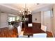 Open concept kitchen and dining area with granite counters, stainless steel appliances, and hardwood floors at 235 Cocoanut Ave # 113C, Sarasota, FL 34236