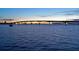 Tranquil scene of a bridge over water at dusk, with a sailboat in the foreground at 235 Cocoanut Ave # 113C, Sarasota, FL 34236