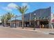 Bustling outdoor cafe with palm trees and brick street at 235 Cocoanut Ave # 113C, Sarasota, FL 34236