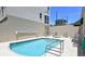 Inviting community pool with hot tub and lounge chairs at 235 Cocoanut Ave # 113C, Sarasota, FL 34236