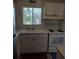 Kitchen with white cabinets, electric stove and sink at 1837 Flamingo Blvd # O35, Bradenton, FL 34207